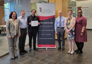 Eman Mirdamadi received first prize in the 2024 Graduate Translational Research Award competition. Dr. Lowe, Dr. Purnell, Phil Robilotto, Dr. Bettes, and Dr. Blackman (left to right) presented him with an award certificate.